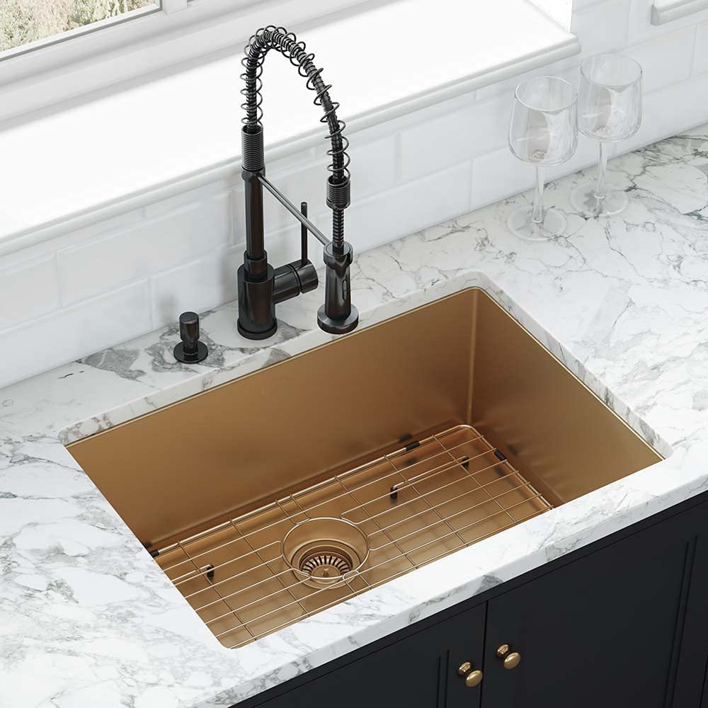 Gold undermount stainless steel kitchen sink installed below a marble countertop